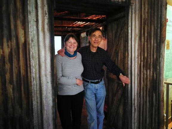 Woman and Man standing in a cabin doorway