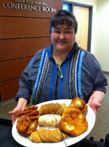 Woman standing with baked items on a platter
