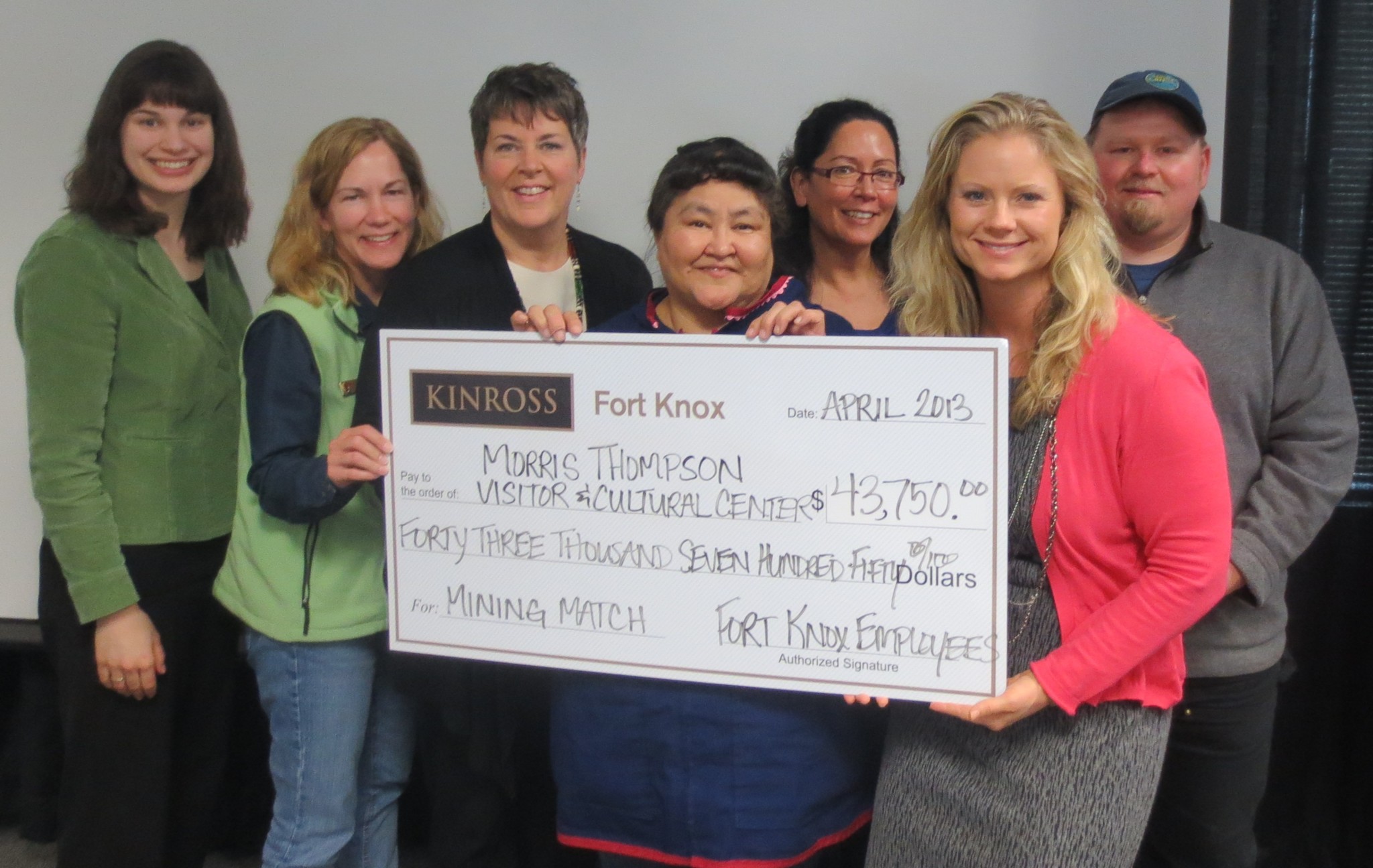 Anna Atchison (far right), Government Relations Manager, presents Kinross Fort Knox's mining match gift to the campaign. 