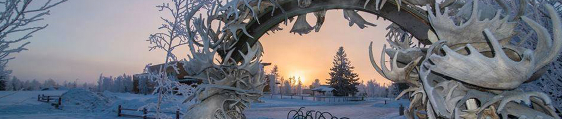 Antler Arch in winter with setting sun in the background at Morris Thompson Cultural and Visitors Center.