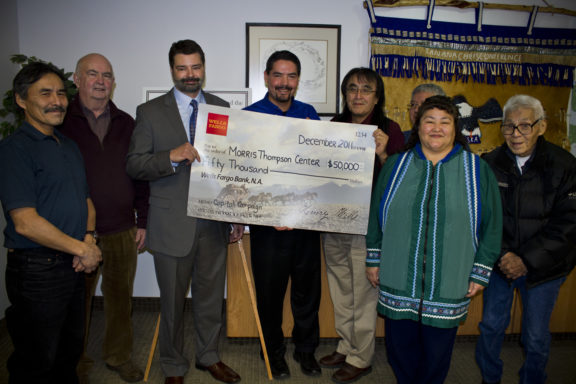 People Posing with Check Illustrating Donation